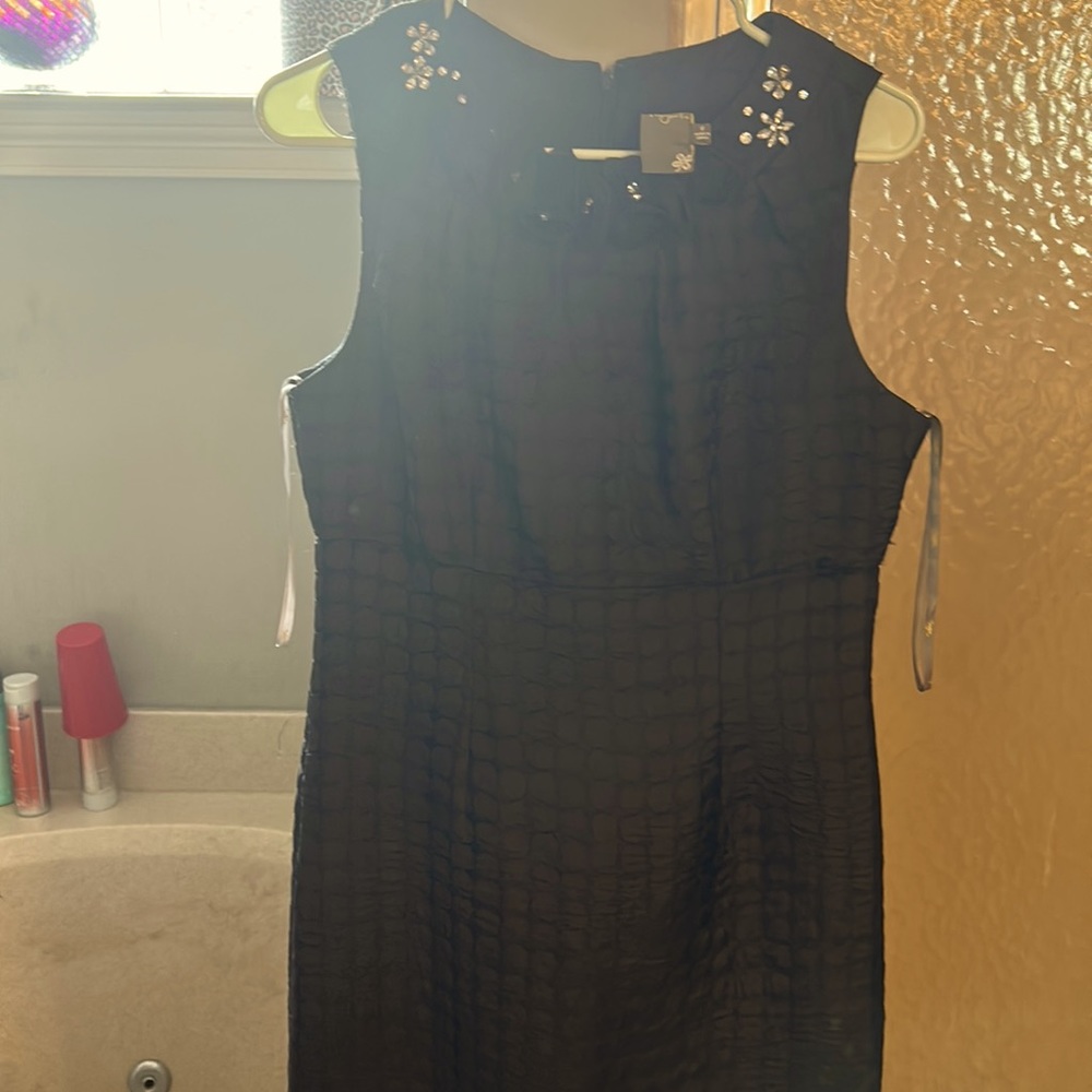 Textured dress with some rhinestones on the collar.
